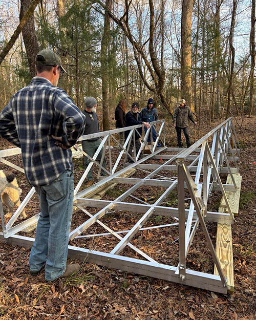 Volunteers installing a bridge